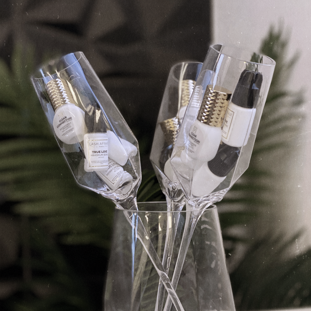 lash-affair-holiday-tips-for-eyelash-extension-artists-adhesive-in-champagne-glasses