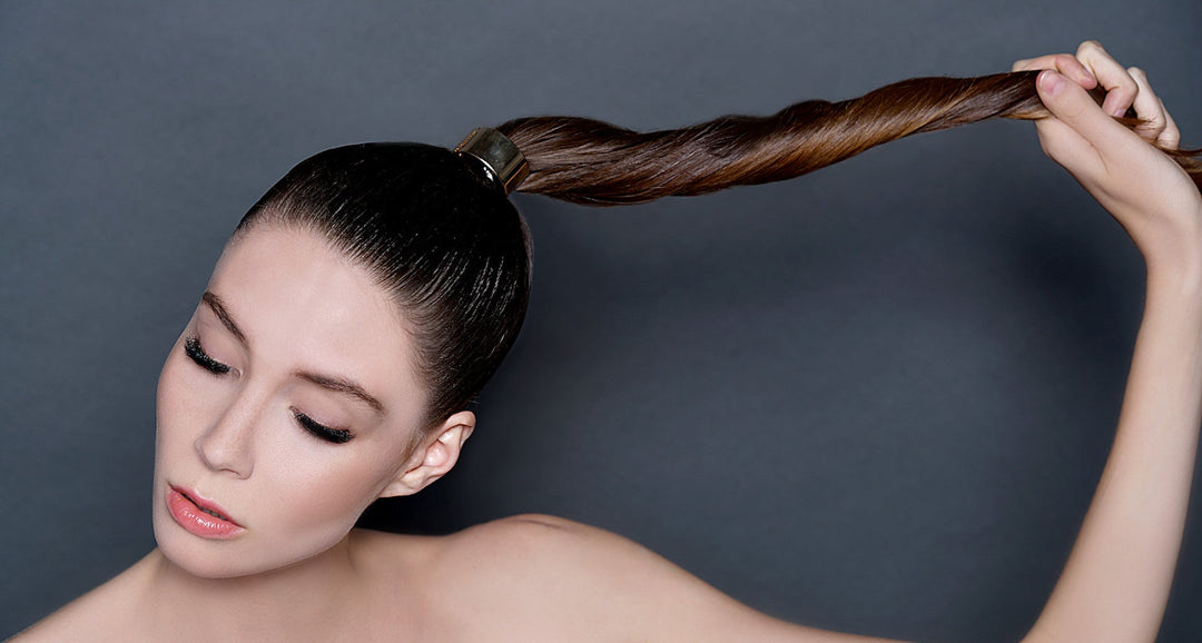 Girl wearing lash affair lash extensions pulling her hair braid